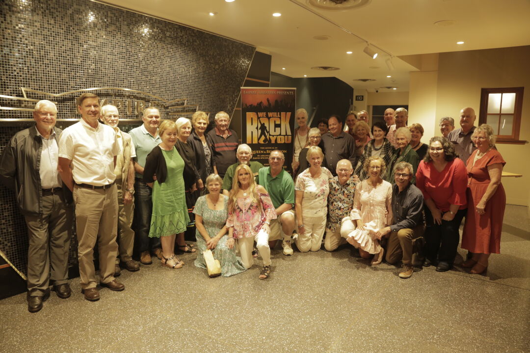 Group of volunteers taking a group photograph in the theatre