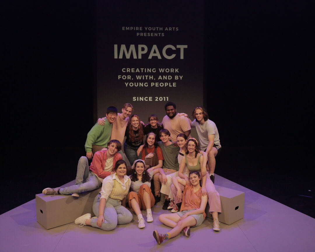 Impact ensemble members positioned in front of a banner for Impact Ensemble.