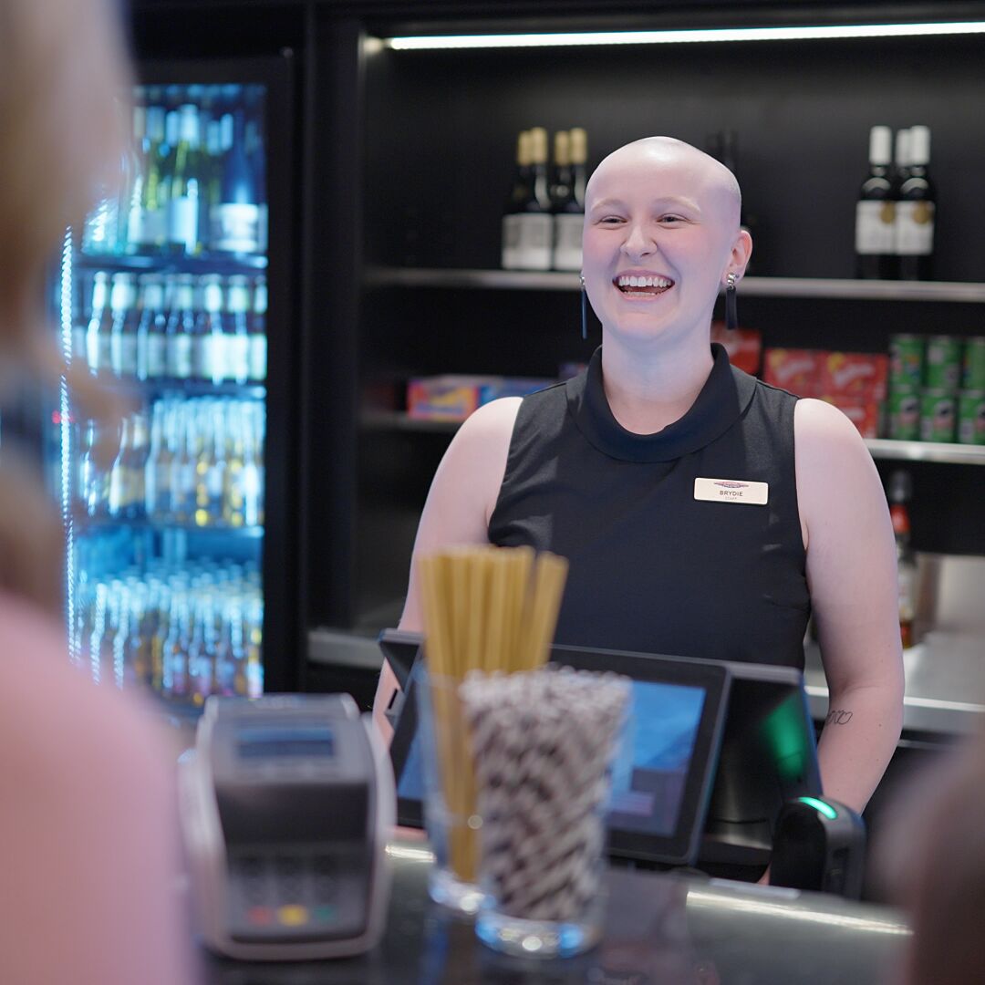Bar staff greeting customers.