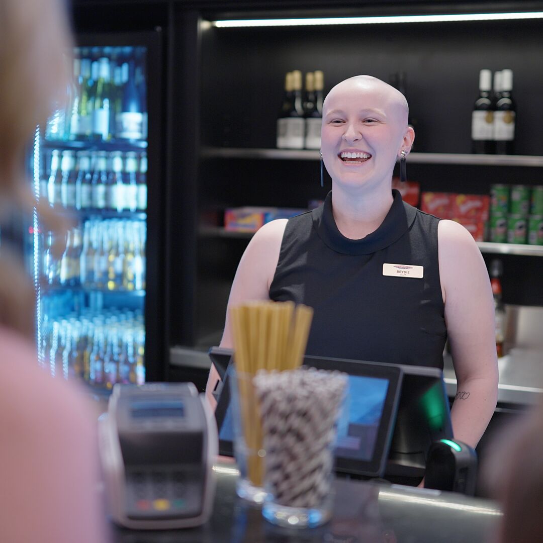 Bar staff greeting customers. 