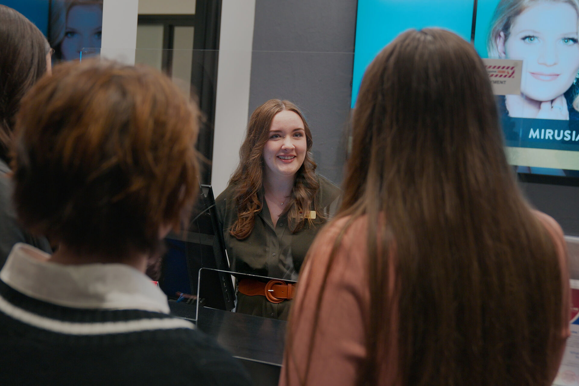 Empire staff-member smiling while talking to customers